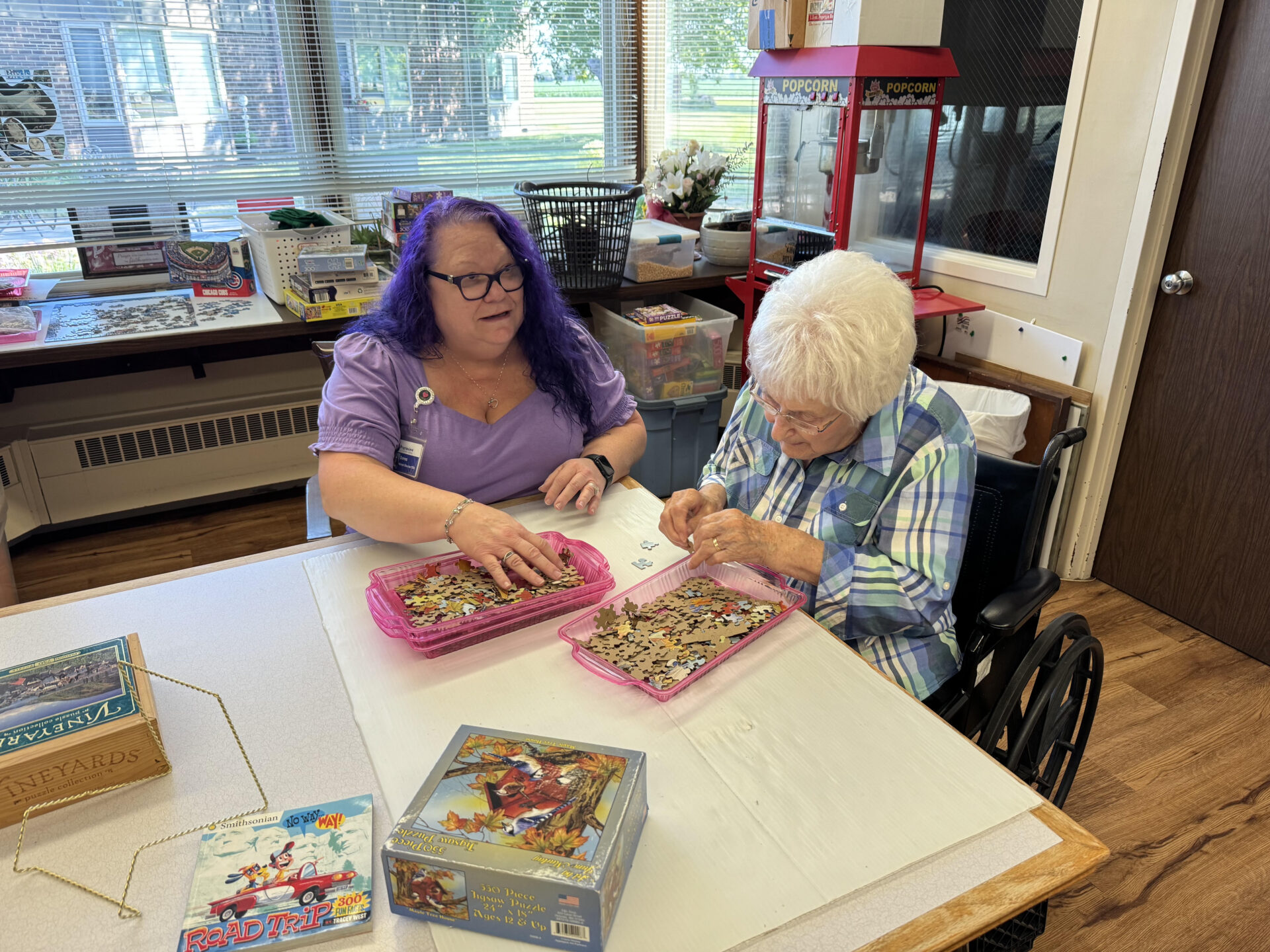 Two women assembling a jigsaw puzzle at a table